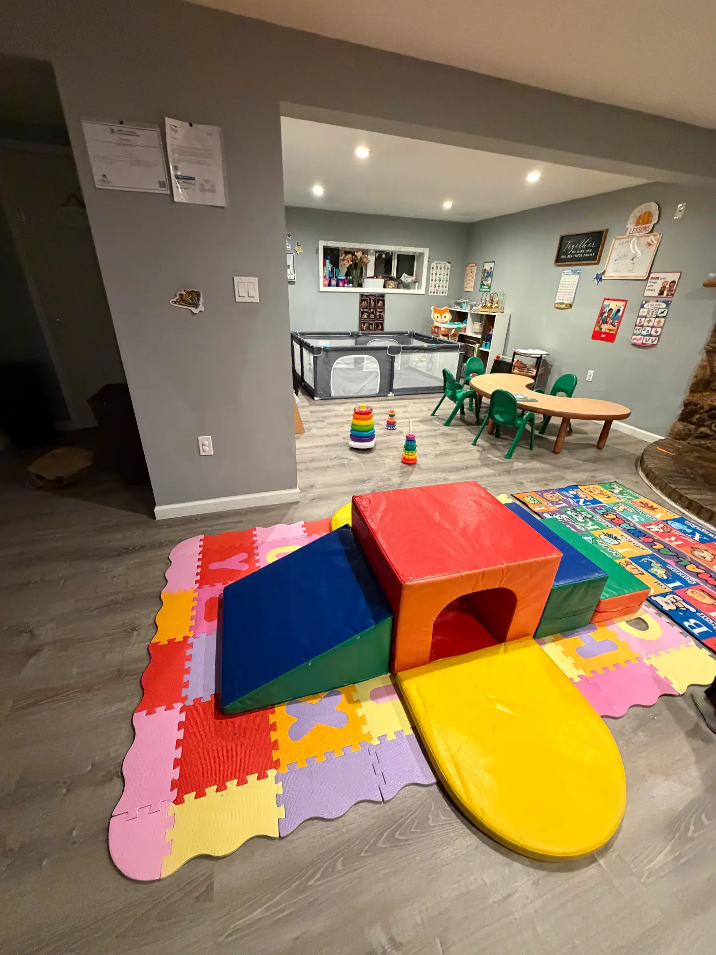 Soft foam climbing shapes in the foreground with the reading and table area beyond